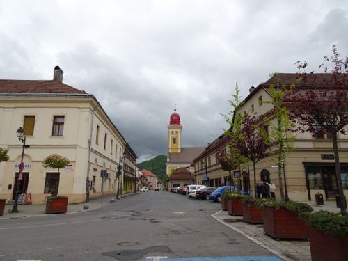 Free Charming European cityscape featuring historic architecture and a bright church tower under cloudy skies in Baia Mare, Romania. Stock Photo