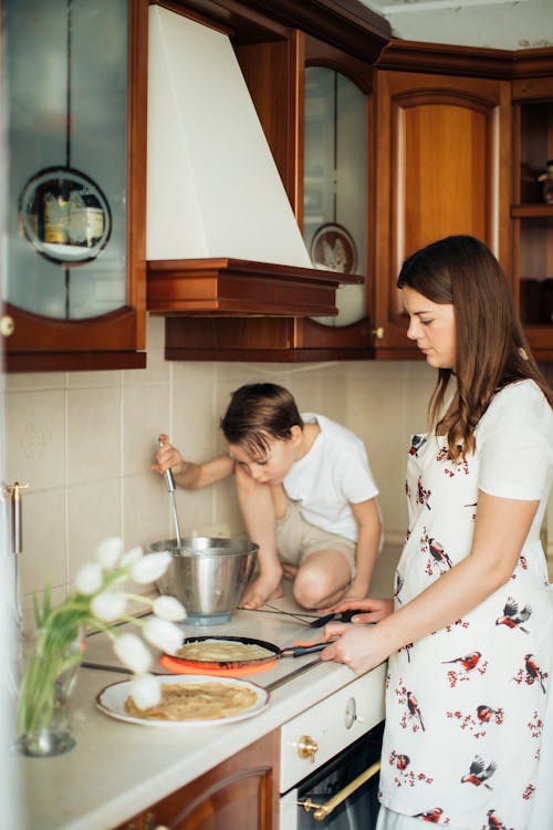 Photo of Woman Cooking in Electric Stove