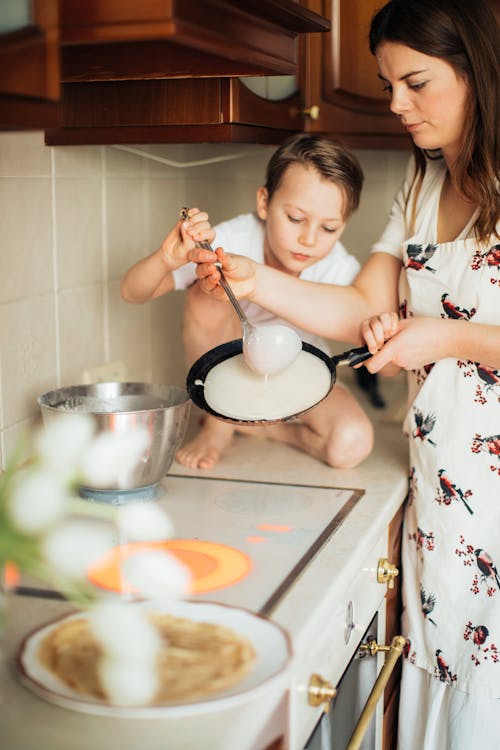 Free Mother and Child Preparing Crepes Stock Photo