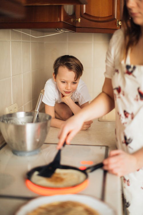 Free Photo of Boy Watching His Mom Cooking Stock Photo