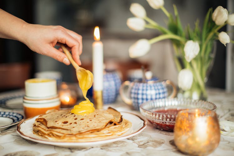 Person Filling Crepe With Custard