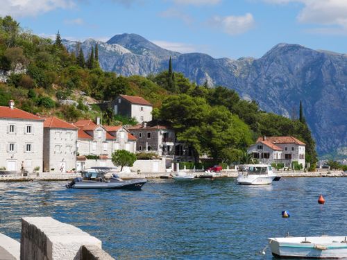 Free Charming coastal village of Perast with boats and mountains, perfect travel destination in Montenegro. Stock Photo