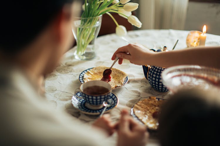 Person Spreading Jam On Crepe