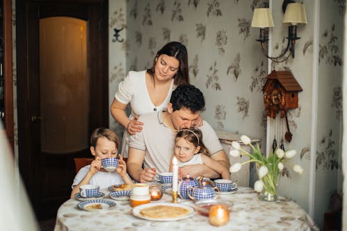 Free Cheerful family drinking tea at home Stock Photo