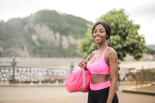 Woman Smiling While in Pink Sports Bra