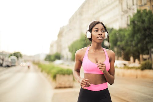 Free Woman in Pink Sports Bra and Black Leggings Jogging Stock Photo