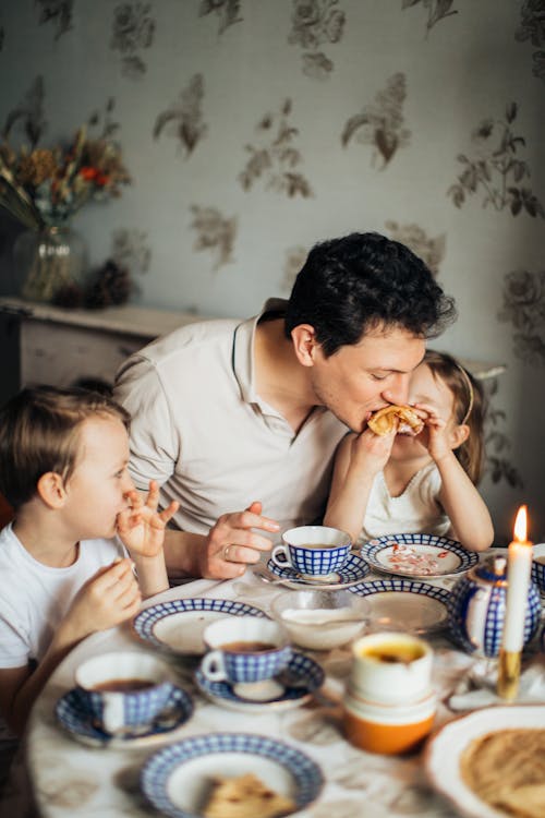 Free Family Sitting at Table Stock Photo