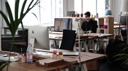 Free Man Sitting in Front of Computer Stock Photo