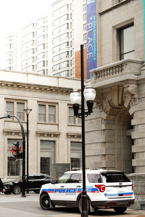 Free Police car parked on an urban street next to architectural buildings in daylight. Stock Photo