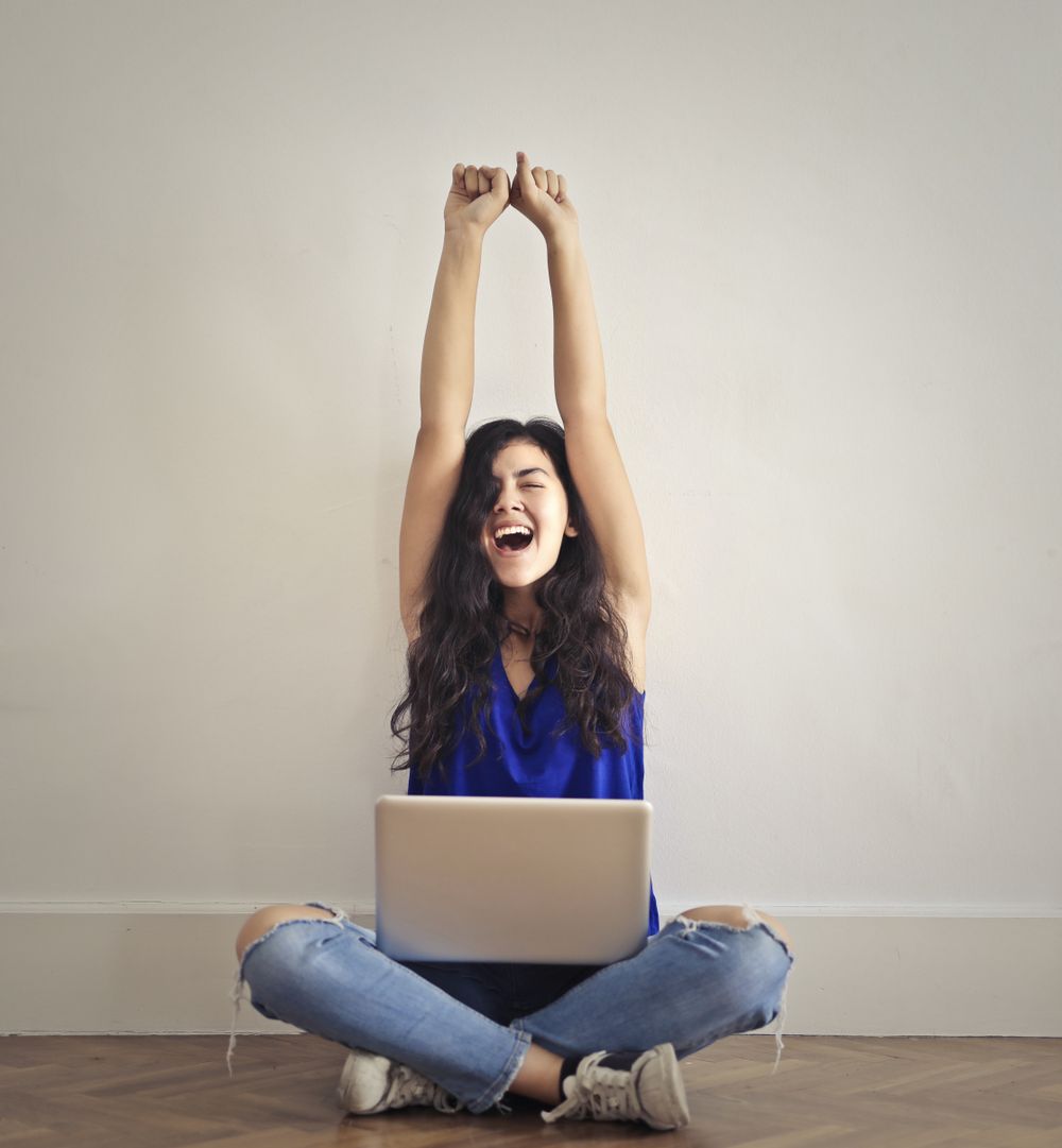 happy girl with laptop after achievement