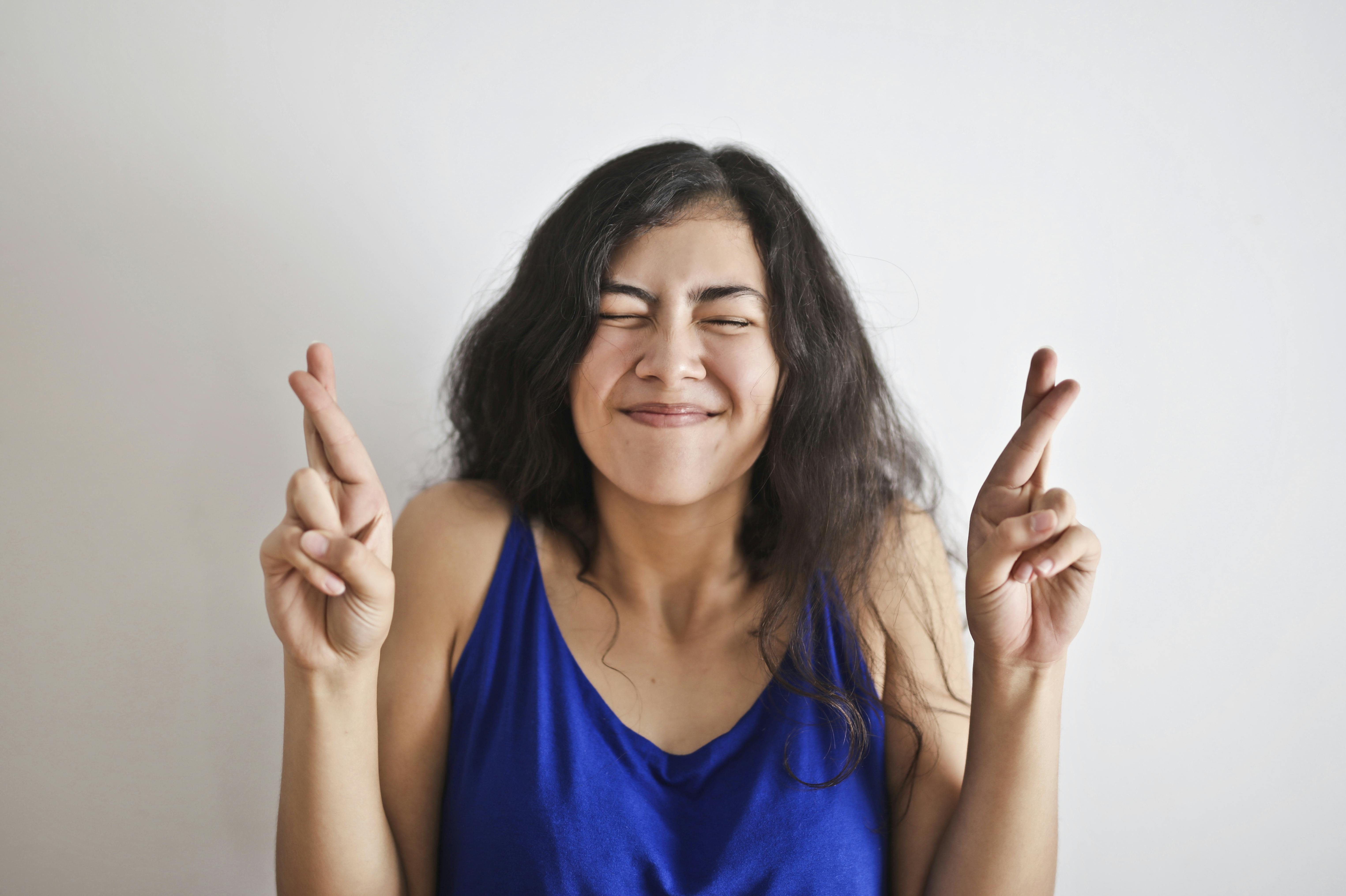 woman in blue tank top smiling