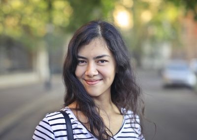 Young woman smiling outdoors