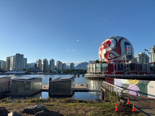 Free View of Vancouver skyline featuring Science World and a giant soccer ball at sunset. Stock Photo