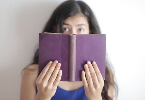 Free Smart woman with book looking at camera Stock Photo