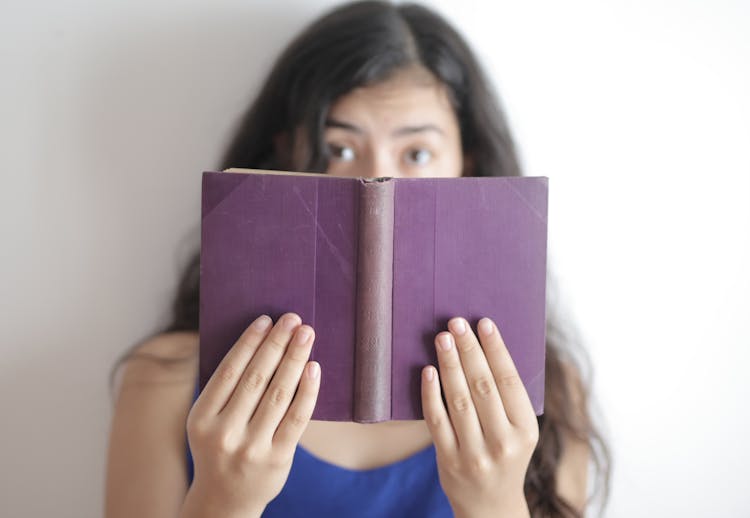 Smart Woman With Book Looking At Camera