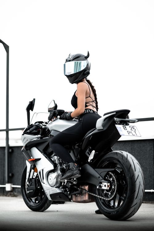 Free A motorcyclist wearing black gear on a sleek sport bike in an urban setting. Stock Photo
