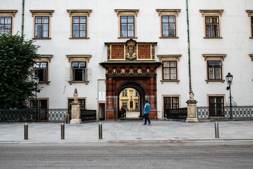 Free Exterior view of a historic European building with ornate details and an arched entrance. Stock Photo