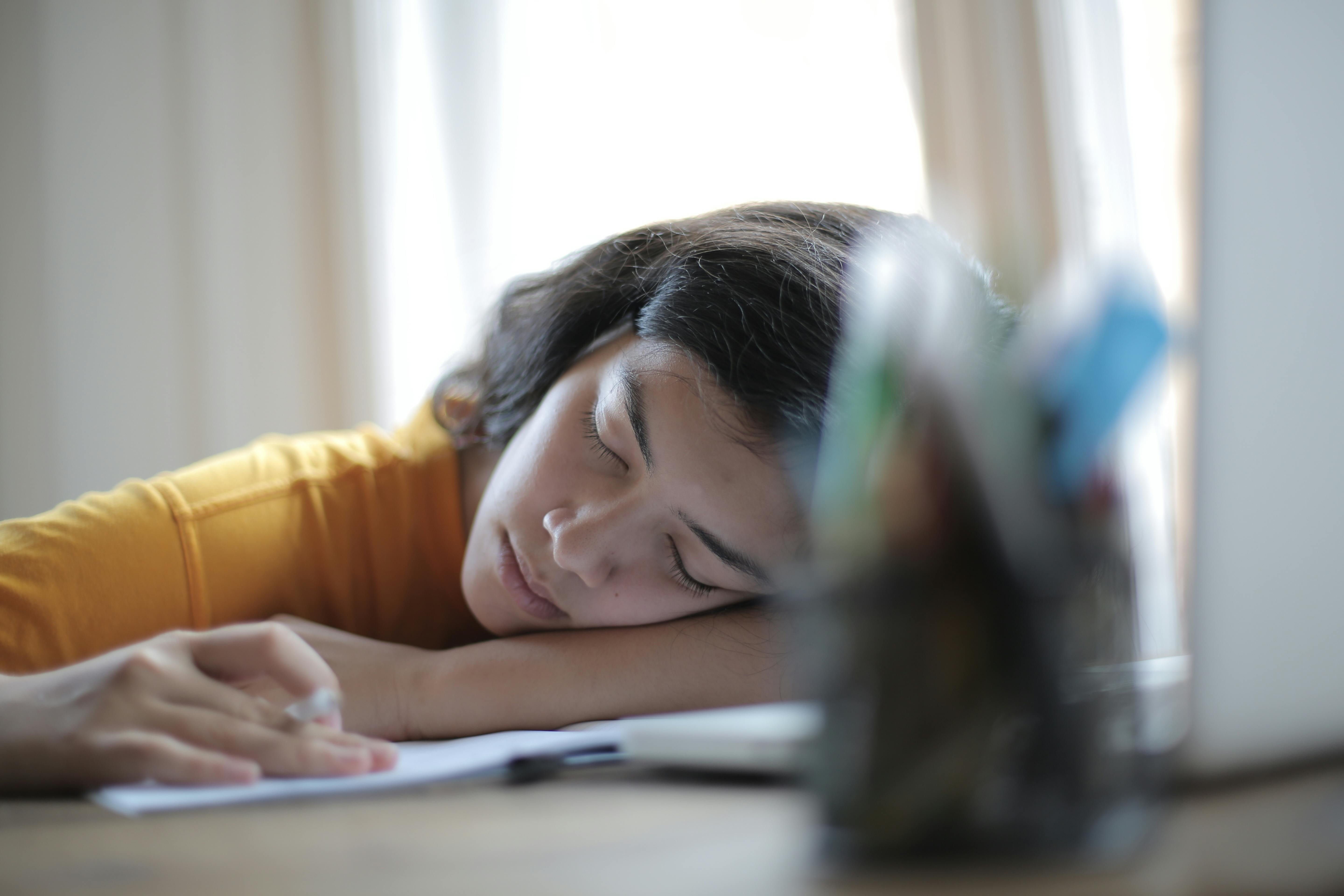 woman in yellow shirt resting on her arm