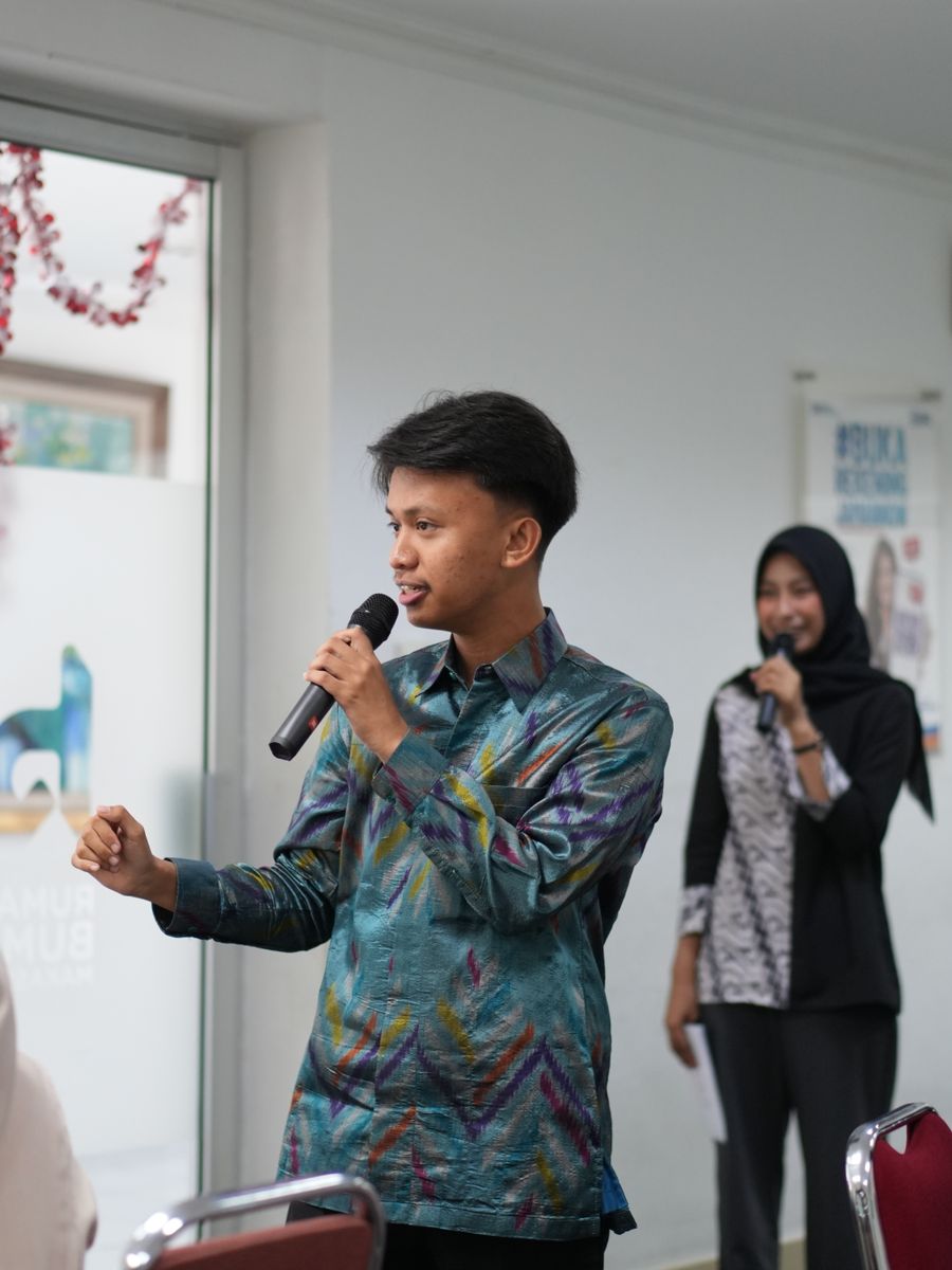 Two speakers presenting with microphones