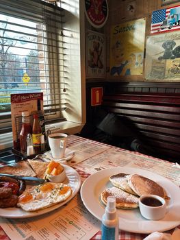 Delicious breakfast with pancakes and eggs in a Warsaw diner, showcasing retro decor and cozy atmosphere.