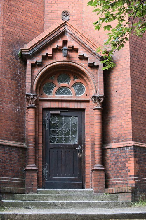 Free Explore a vintage archway with brickwork and ornate iron detailing, perfect for historic architecture enthusiasts. Stock Photo