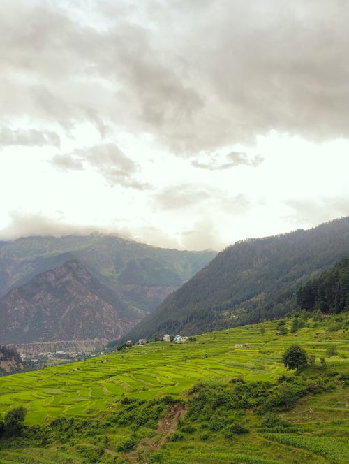 Free Beautiful landscape of terraced fields and mountains under a cloudy sky. Stock Photo