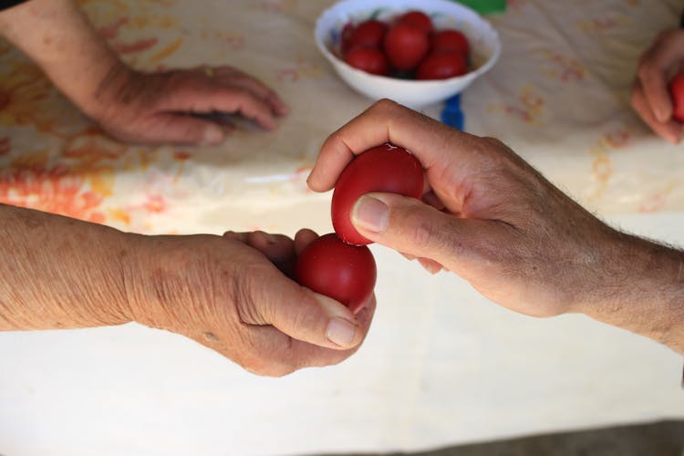 Crop People Tapping Easter Eggs