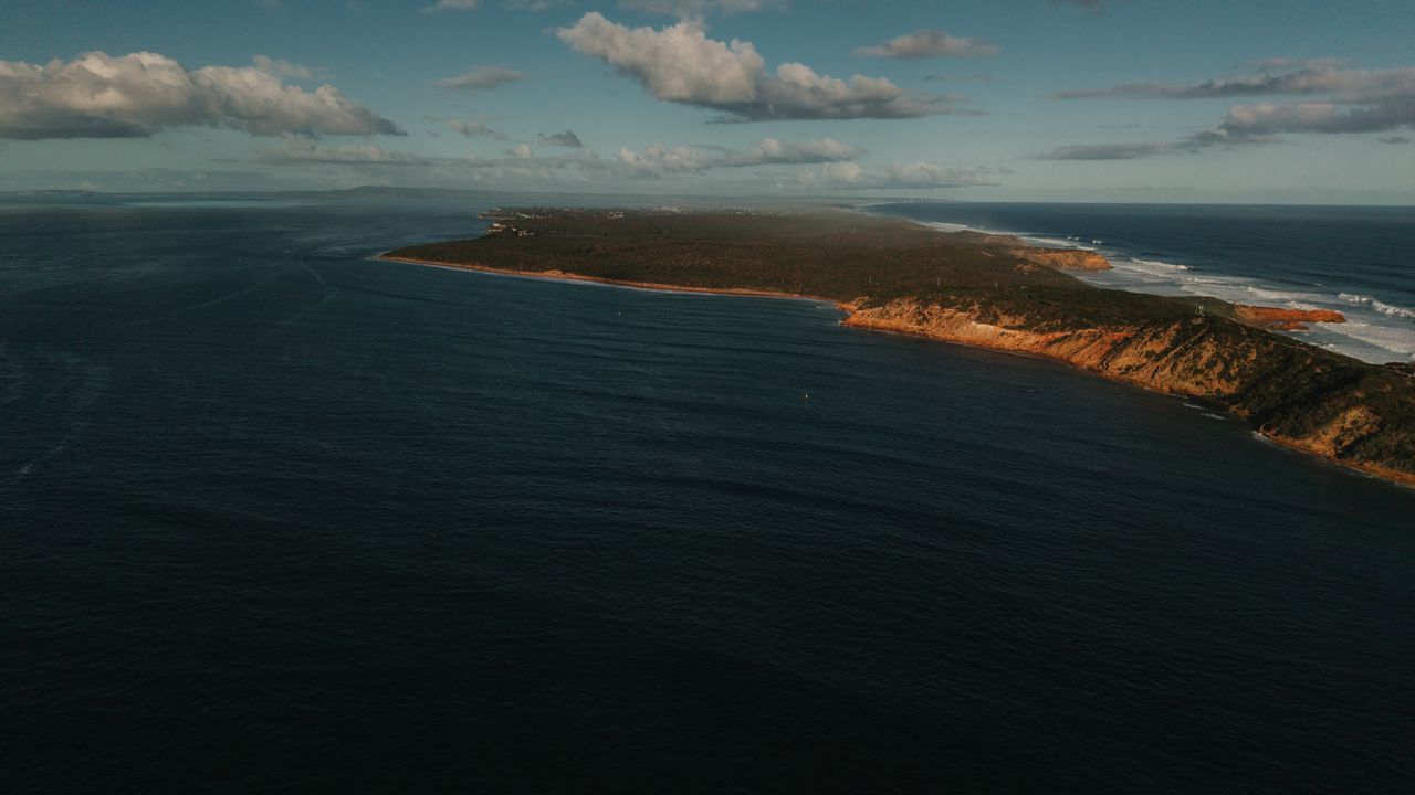 a breathtaking aerial view of the rugged coastline of portsea victoria