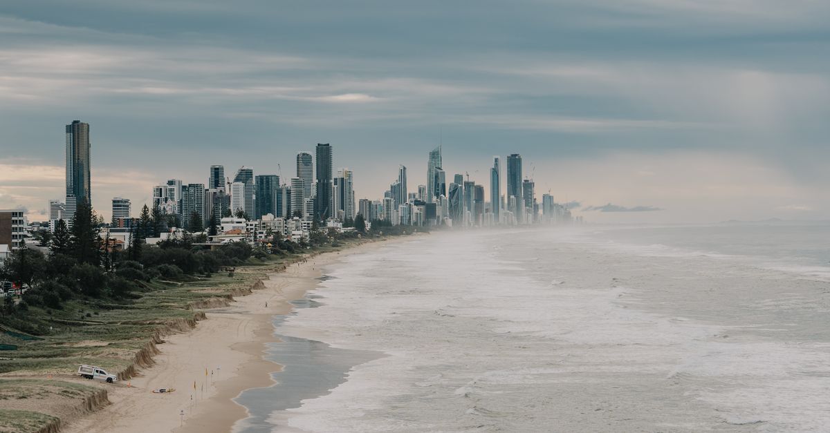 A breathtaking view of Gold Coast's skyline and beach under a cloudy sky.