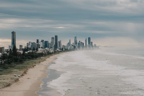 Free A breathtaking view of Gold Coast's skyline and beach under a cloudy sky. Stock Photo