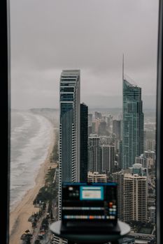 Aerial view of the Gold Coast skyline with overcast sky and a focus on modern skyscrapers.