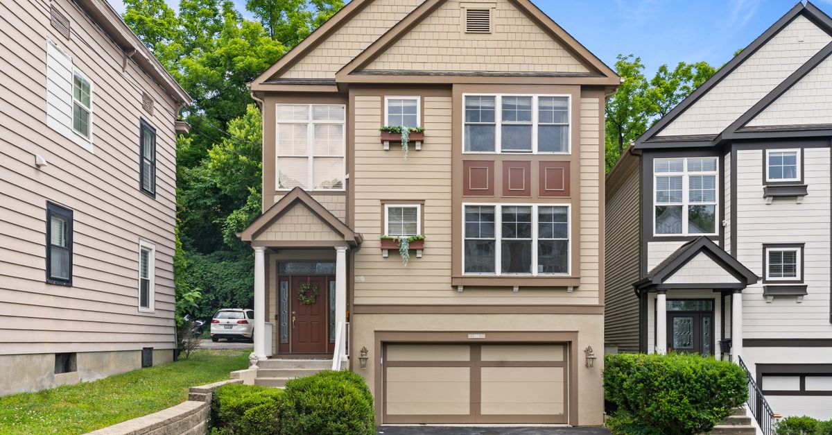 Front view of a modern suburban home in Cincinnati, Ohio with a garage and garden.