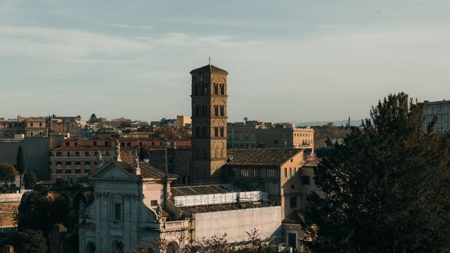 A stunning view of historic Roman architecture bathed in warm sunset light, showcasing iconic structures in Rome, Italy. — lounges at Rome Fiumicino Airport