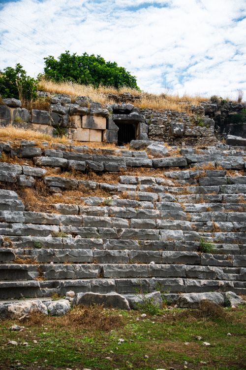 Free Explore the historical stone ruins of an ancient amphitheater surrounded by nature. Stock Photo