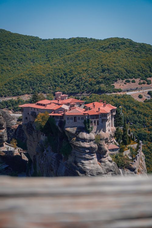 Free Stunning view of a historic Meteora Monastery clinging to dramatic rocky cliffs in Greece on a sunny day. Stock Photo