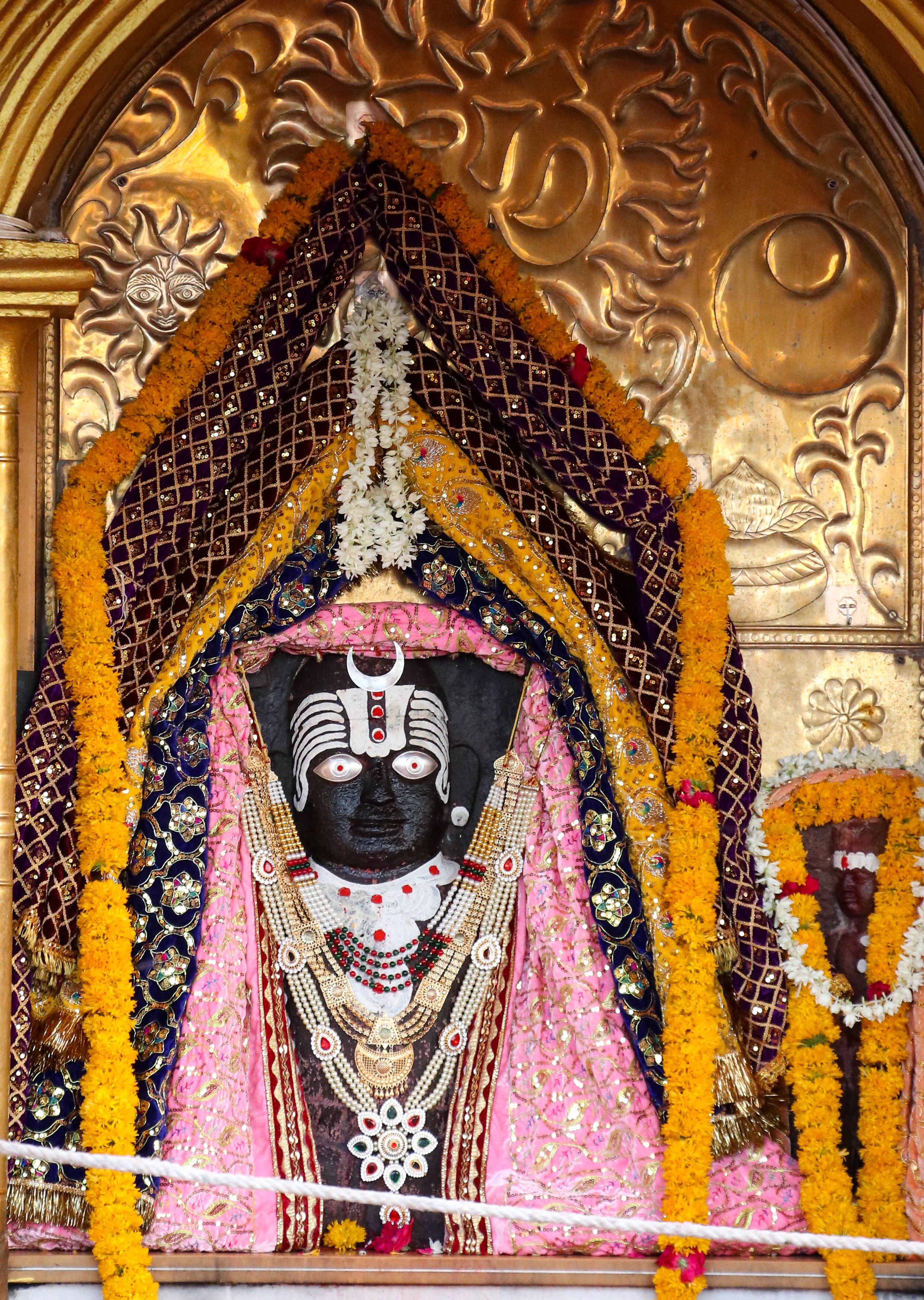 Intricate idol adorned with flowers at Mahakaleshwar Temple, Ujjain, showcasing traditional Indian craftsmanship.