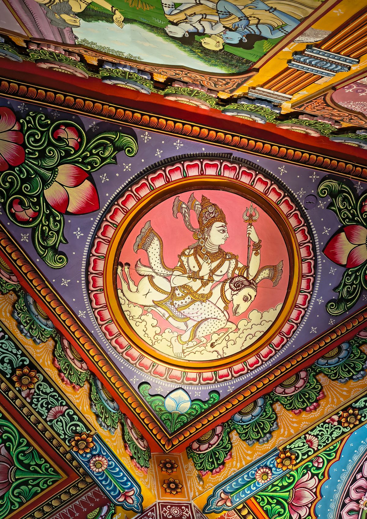Vibrant Hindu temple mural artwork with intricate deity figures in the traditional Indian mural style