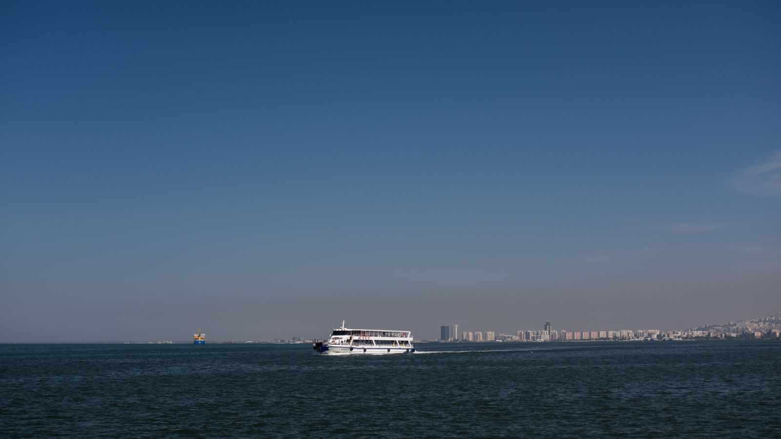 Ferry on the aegean sea with izmir skyline, Mozambique