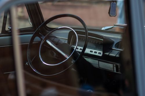 Free Close-up view of a vintage car's interior showcasing the steering wheel and dashboard design. Stock Photo