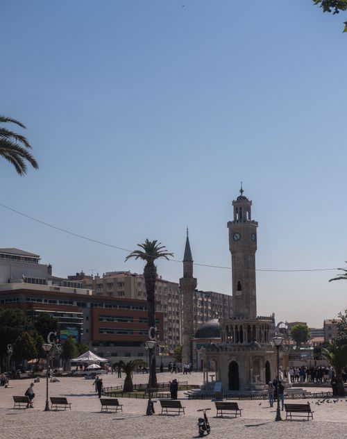 Free A vibrant view of Izmir's iconic clock tower surrounded by city life and clear blue skies. Stock Photo