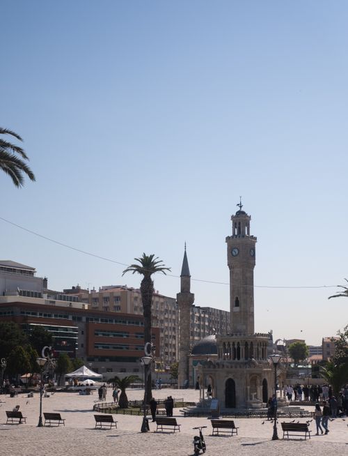 Free The iconic İzmir Clock Tower stands proudly in sunny Konak Square, surrounded by palm trees. Stock Photo