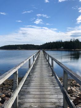 A picturesque wooden pier extending into the sea at Winter Harbor, Maine.