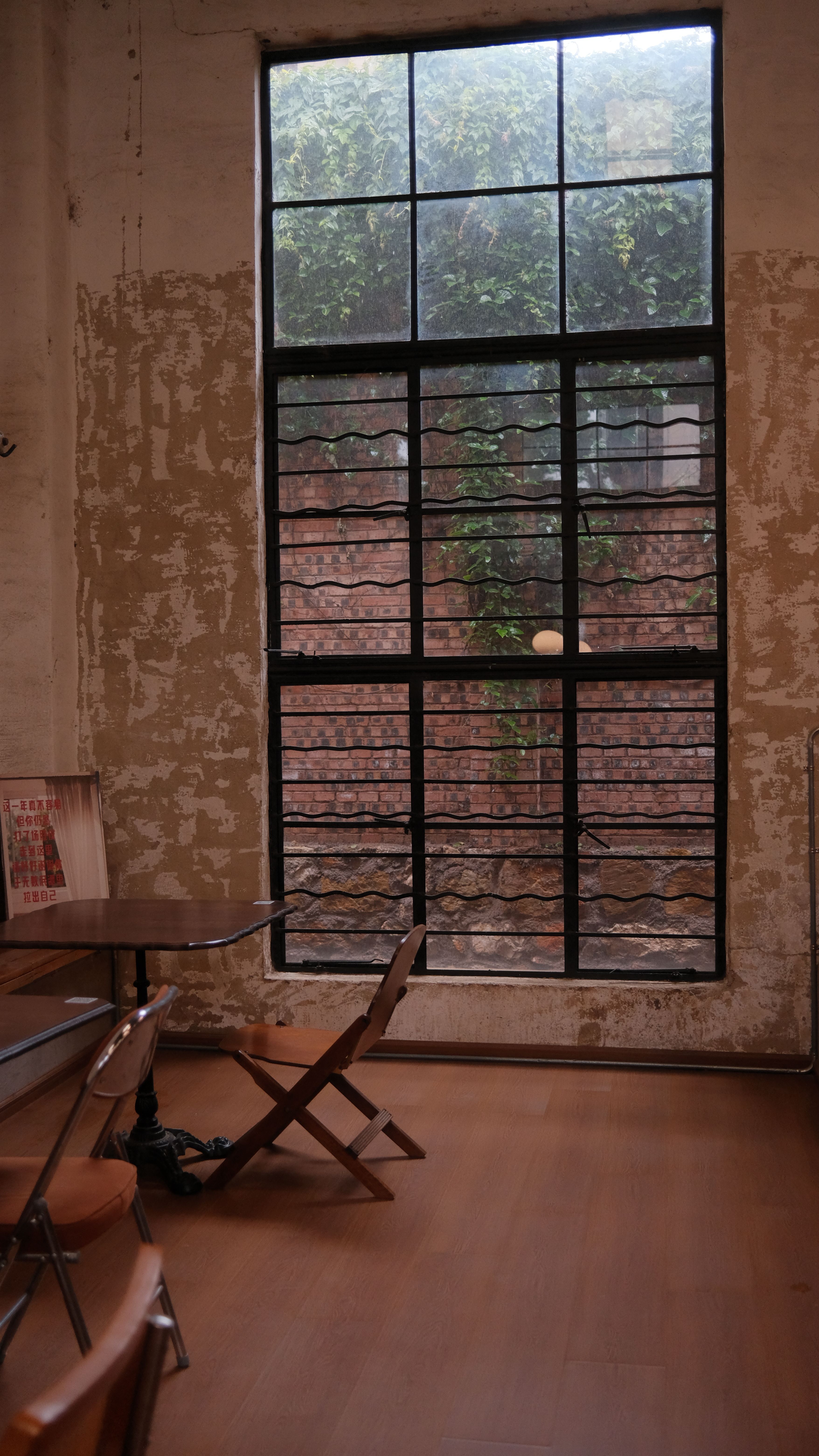 A rustic room with industrial decor, featuring a large window with metal bars and wooden furniture.. pexels, rustic, room