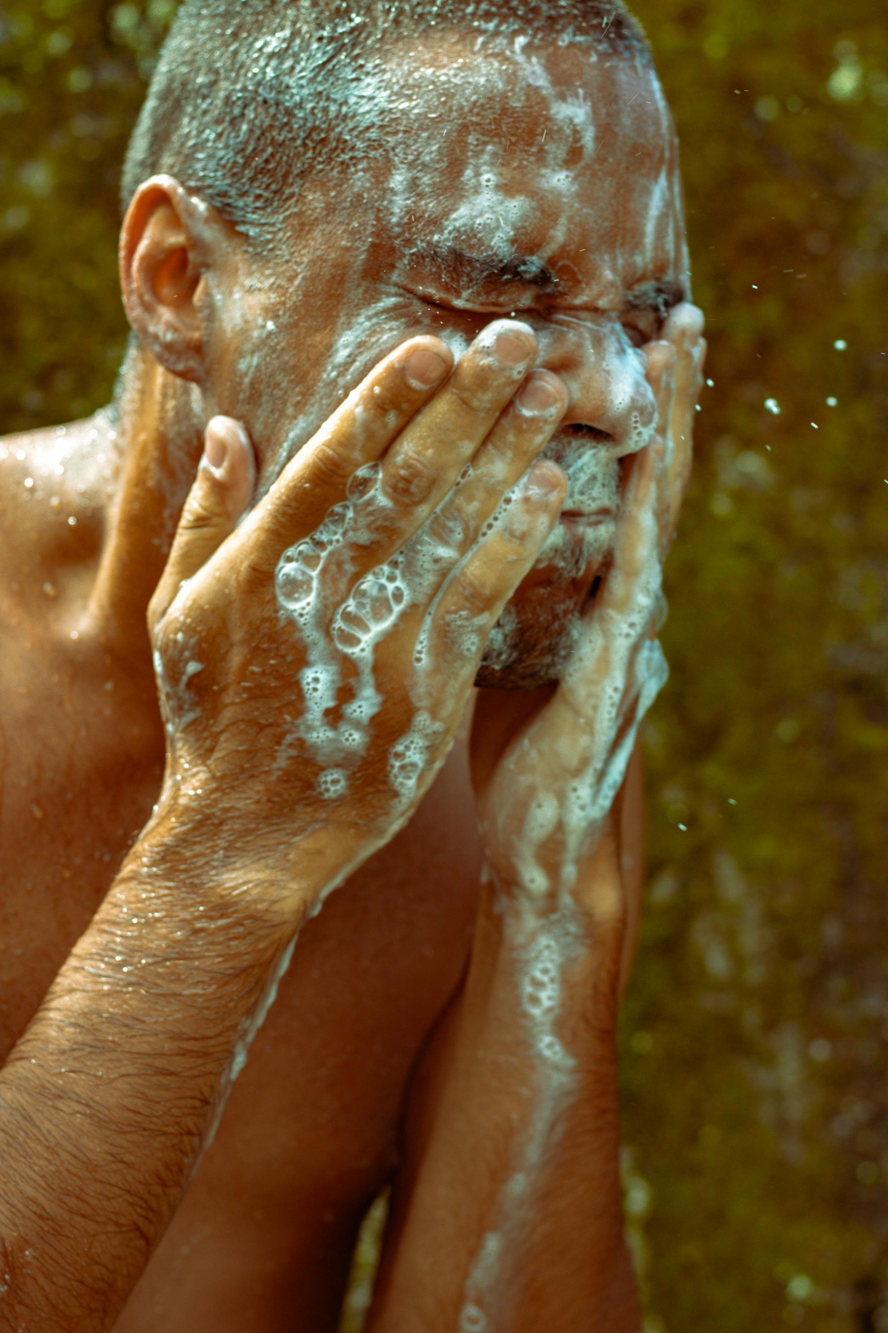 Topless Man Washing His Face