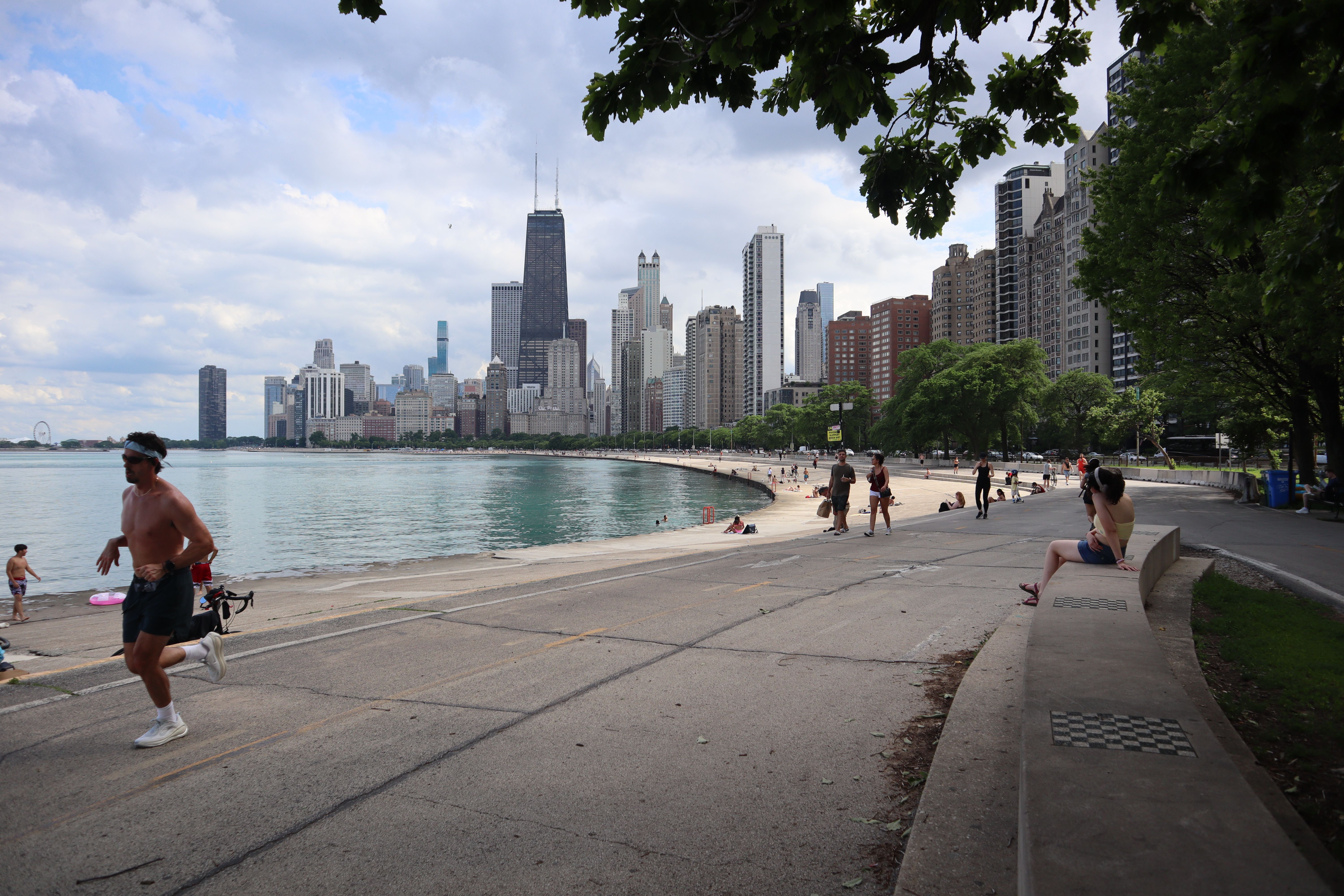 Scenic view of Chicago skyline from Lake Michigan trail with runners and cityscape view.
