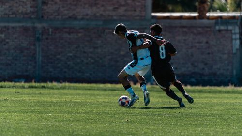 Free Two soccer players vie for possession during a daytime match. Stock Photo