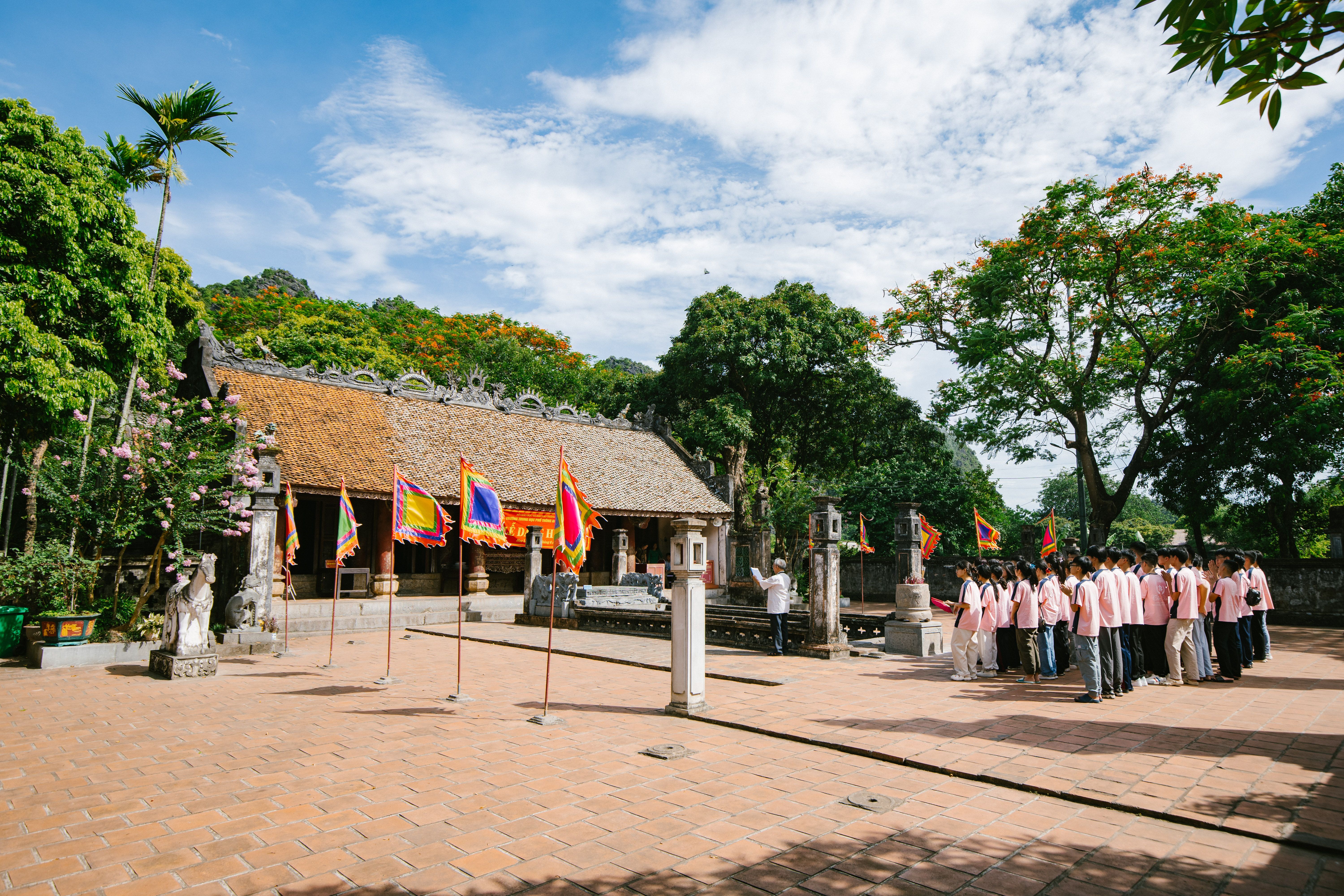 A peaceful scene of a traditional ceremony at Bai Dinh Pagoda in Ninh Bình, Vietnam under clear skies.