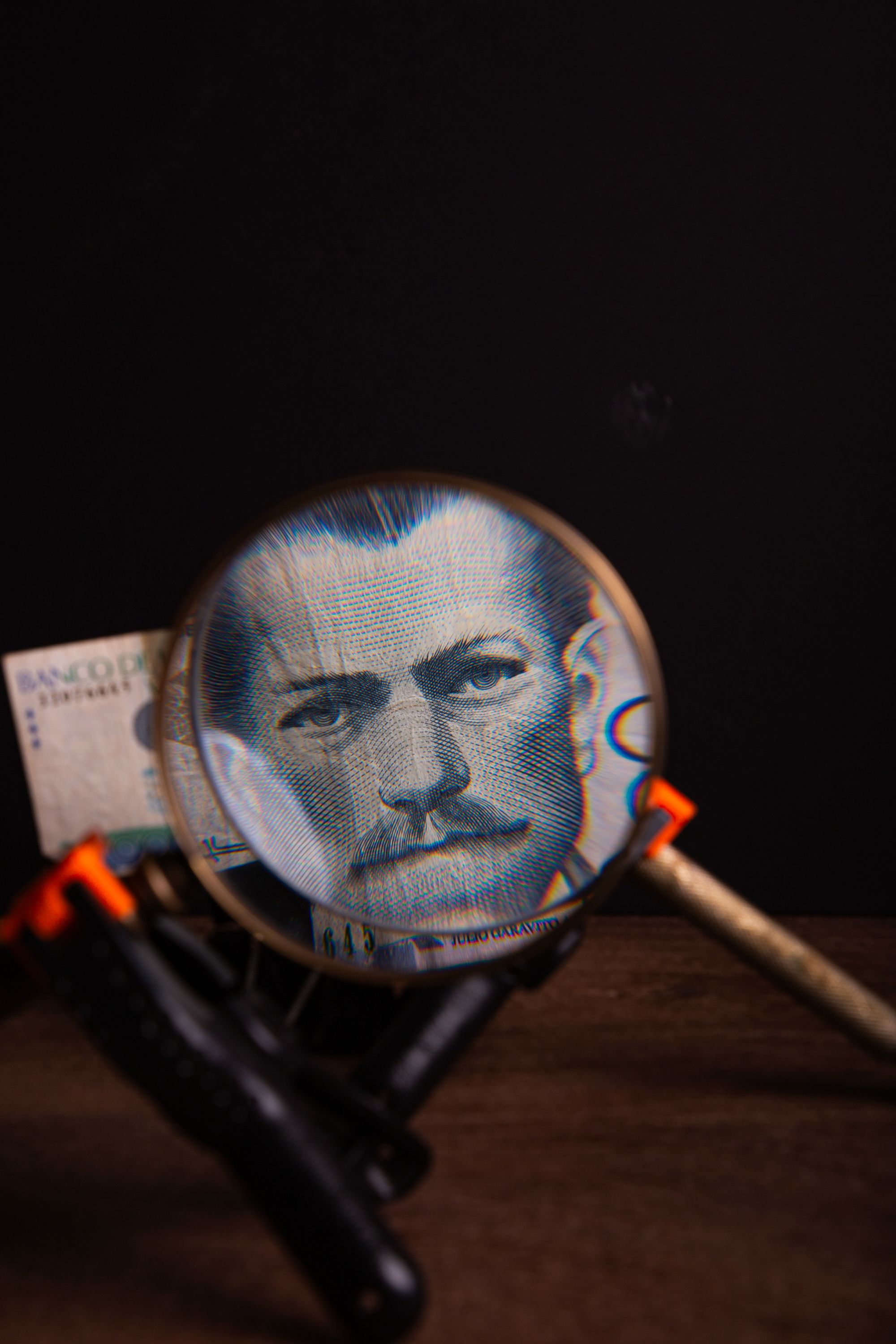 Close-up of a vintage banknote magnified, emphasizing intricate details and artistic design.