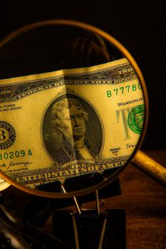 Detailed view of Thomas Jefferson on a US two dollar bill magnified by a lens.