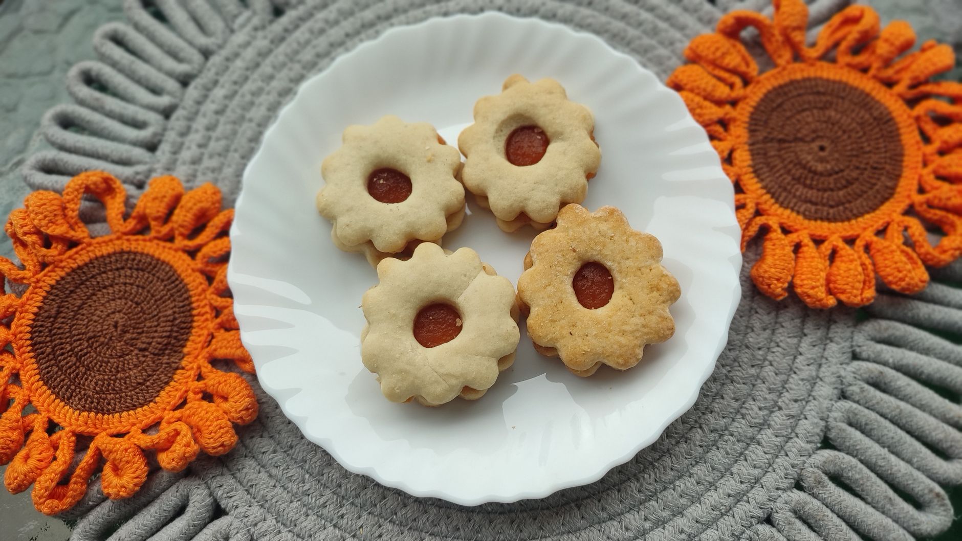 Close-up of almond pieces and sugar-free icing drizzle on cookies